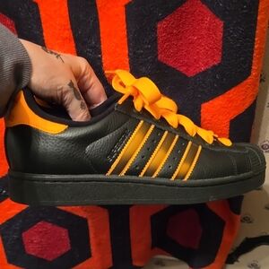 Adidas Superstar II shoe in Core Black, Crew Orange, and Semi Impact Orange.